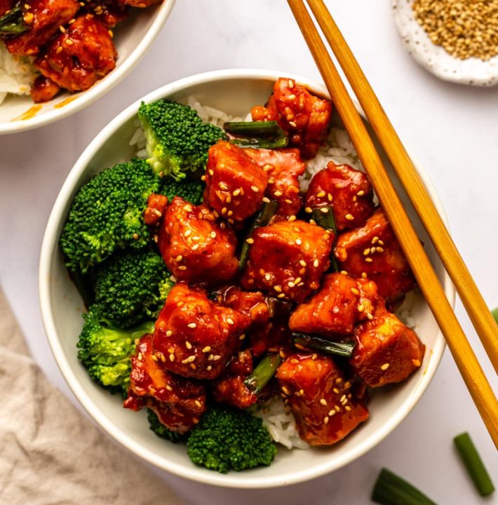 Bowl of gochujang tofu over rice with a side of broccoli
