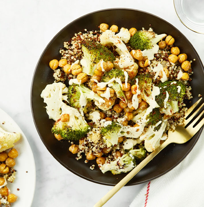 Roasted broccoli, cauliflower and chickpeas over quinoa with dressing